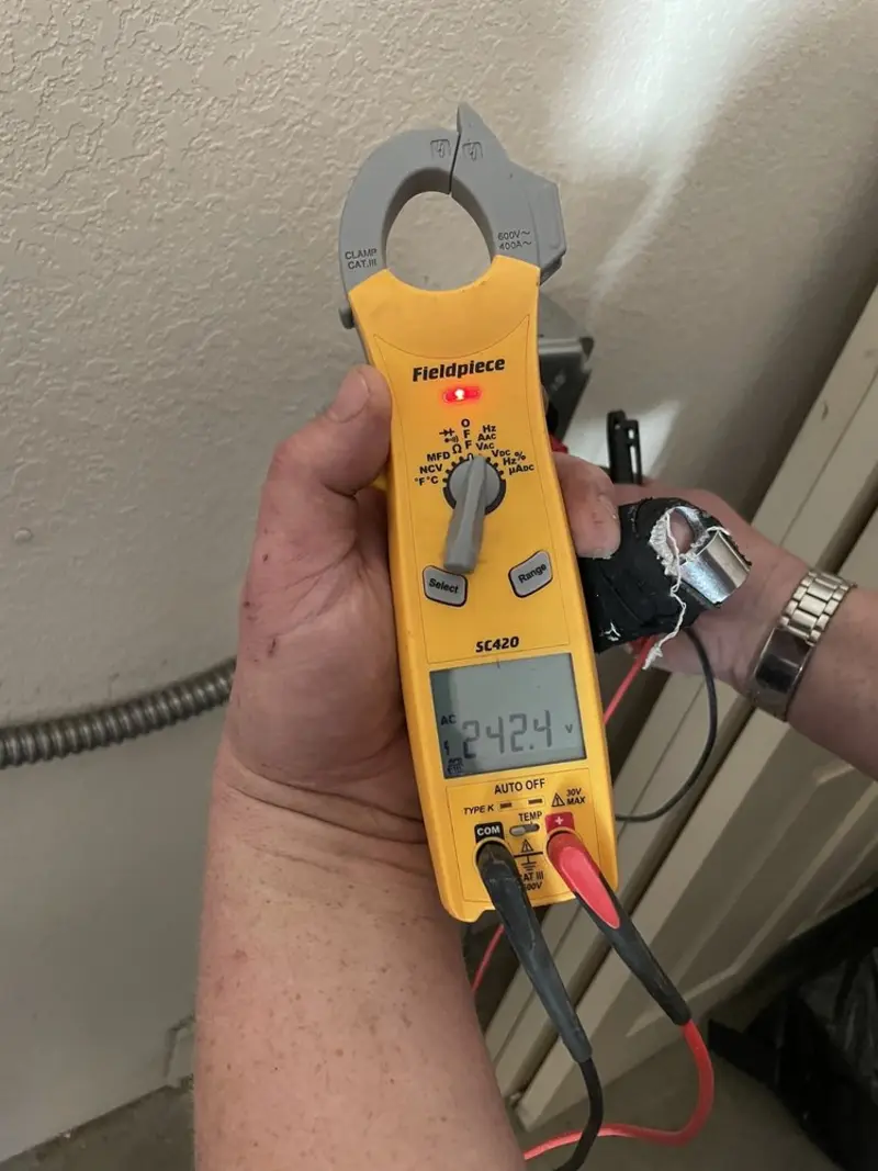 Voltage testing with clamp meter during Electrical Installation Services in Egelston